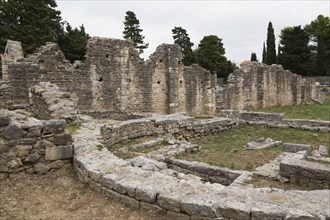 Old semi circle stone structure and walls at ancient 3rd century Roman ruins of Salona near Solin