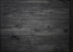 The rich, dark wood surface features intricate grain patterns and textures, creating a warm and