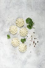 Khinkali, a traditional Georgian dish, with spices and herbs, top view, no people, on the grey