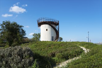 An old mill with spiral staircase, surrounded by nature and under a blue sky, old mill of La Croix,