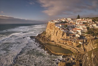 Scenic view of the seaside Azenhas do Mar fishing village on cliff on Atlantic ocean coast,