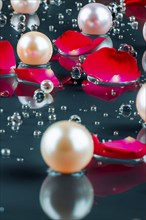 Pearl necklace in the water with splashes, drops and reflections, AI generated