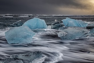 Ice floes in the sea during a storm and heavy spray, Breidamerkursandur, Jökulsarlon, south-east