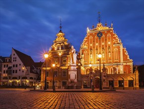 Riga Town Hall Square, House of the Blackheads and St. Roland Statue illuminated in the evening