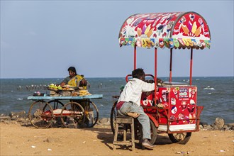 PONDICHERRY, INDIA, FEBRUARY 2, 2013: Unidentified Indian street vendors of ice cream and snacks