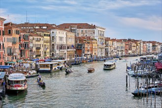 VENICE, ITALY, JUNE 27, 2018: Grand Canal with boats, vaporetto and gondolas on sunset from Rialto