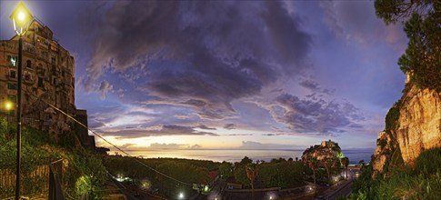 Sea view with the medieval old town of Tropeain the evening twilight, Tropea, Calabria, Vibo