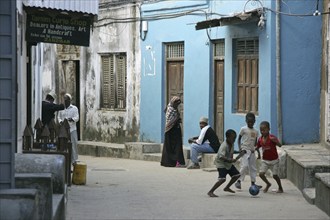 Black children playing in alley of the old medina of Stone Town, Stonetown, Mji Mkongwe, Zanzibar,