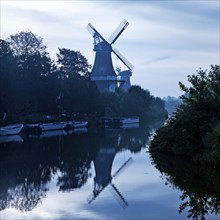 Twin mills at the Old Greetsiel Low Seal in the early morning, Greetsiel, Krummhörn, East Frisia,