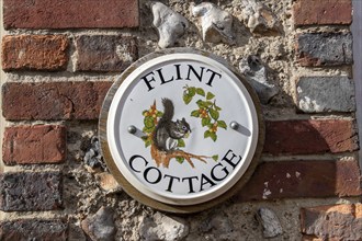 Painted tile on a house wall, Alfriston, East Sussex, England, Great Britain