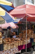 Woman selling bread, stall, Osh bazaar, Bishkek, Kyrgyzstan, Asia