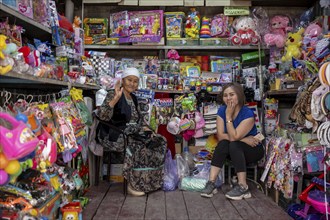 Two woman selling toys and magazines, market stall at the Osh Bazaar, Bishkek, Kyrgyzstan, Asia