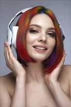 Portrait of beautiful woman with multi-colored hair and creative make up and hairstyle