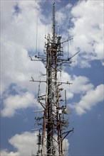 Overloaded antenna mast, here in Naples, Campania, Italy, Europe