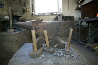 Blacksmith at the Demitz-Thumitz granite works. The granite processing tools have to be reforged,