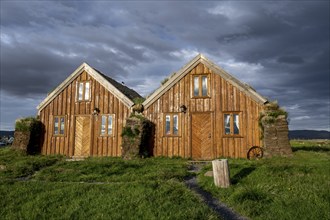 Traditional wooden peat houses with grass on the roof, in the evening light, Möðrudalur, Icelandic