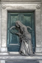 Sculpture of an old woman at a door with an hourglass, Monumental Cemetery, Cimitero monumentale di