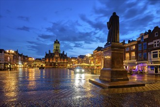 Delft City Hall and Delft Market Square Markt with Hugo de Groot Monument in the evening. Delfth,