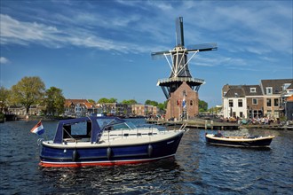 HAARLEM, NETHERLANDS, MAY 6, 2017: Harlem cityscape with windmill De Adriaan on Spaarne river.