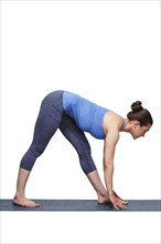 Woman doing Ashtanga Vinyasa yoga asana Parsvottanasana, intense side stretch pose on yoga mat