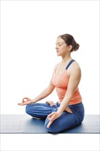 Woman doing Yoga meditation asana Padmasana, lotus pose posture with chin mudra isolated on white