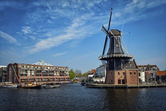 View of Harlem landmark windmill De Adriaan on Spaarne river. Harlem, Netherlands