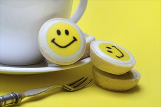 Pastry with smiley face and coffee cup, symbol