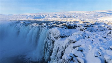 Godafoss waterfall in first morning sun, snow-covered landscape, Northern Iceland Eyestra, Iceland,