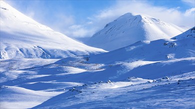 Light and shadow over snowy hilly landscape, near Akureyri, Northern Iceland Eyestra, Iceland,