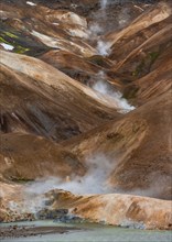 Steaming stream between colourful rhyolite mountains, Hveradalir geothermal area, Kerlingarfjöll,