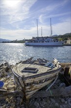 Old boat and behind it ship Meridijan, Kucište, Orebic, Pelješac Peninsula, Dubrovnik-Neretva