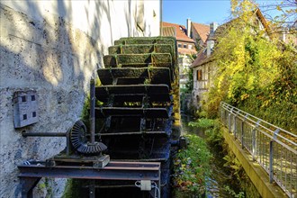 Symbolic image of historical mill wheel and concept of water energy and sustainability, here using