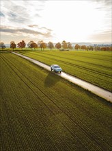 Aerial view of a VW ID4 electric car at sunrise in autumn, Herrenberg, Germany, Europe