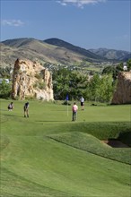 Golden, Colorado, The Fossil Trace Golf Course. Golfers play near footprints of dinosaurs and