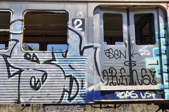 Discarded train carriage, carriage with graffiti, detail with door and window, symbolic image