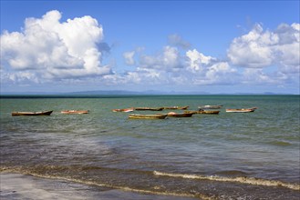 Calm sea with several small boats, fishing boats, blue sky with clouds above, Miches, El Seibo,