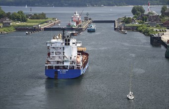 Ships sail to the Kiel-Hiltenau lock facility on the Kiel Canal, Schleswig-Holstein, Germany,