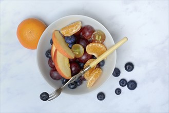 Various pieces of fruit in bowl, fruit salad