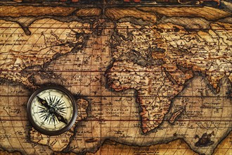 Travel geography navigation concept background, old vintage retro compass on ancient world map