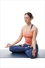 Beautiful fit yogini woman meditating in yoga asana Padmasana (Lotus pose) cross legged position