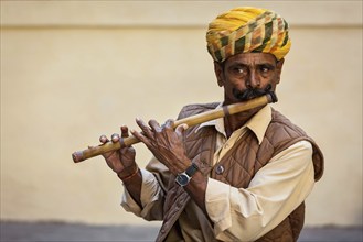 JODHPUR, INDIA, NOVEMBER 26, 2012: Indian man plays wooden flute in Mehrangarh fort, Rajashtan,