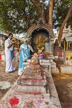 MADURAI, INDIA, FEBRUARY 16, 2013: Indian pilgrim family worshipping Hindu god Ganesh in famous