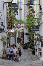 People in a sidewalk café in the old town of Peñíscola, Castellón province, Costa del Azahar,