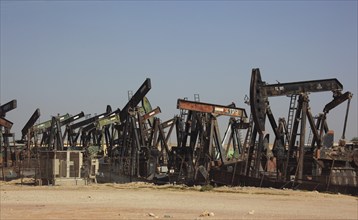 Storage with disused oil pumps near Marmul, Oman, Asia