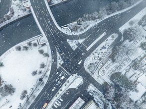 Drone view of snow-covered roads with moving cars in winter, Black Forest, Calw, Germany, Europe