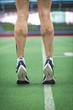 Close-up of a runner's sports shoes on a green stadium floor, Glaspalast, Sindelfingen