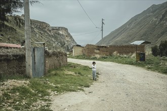 Child on the street in a hamlet, Curipata, Peru, South America