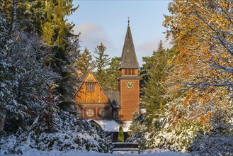 Wooden chapel in the style of Norwegian stave churches in the snow, south-west churchyard, historic