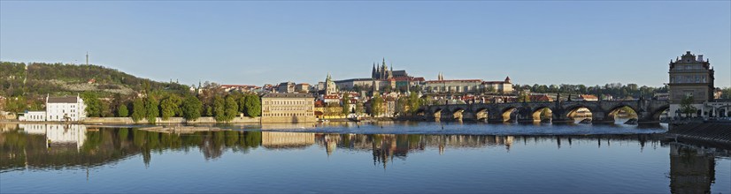 Panorama view of Charles bridge over Vltava river and Gradchany (Prague Castle) and St. Vitus