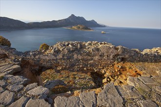 Venetian sea fortress Gramvoussa, lagoon, island, ridge, stone slabs, ruins, blue cloudless sky,